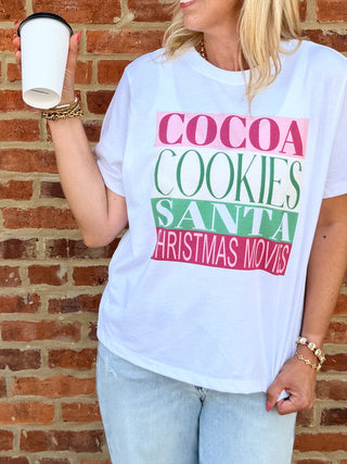 Christmas movie night graphic tee with cocoa, cookies and Santa artwork