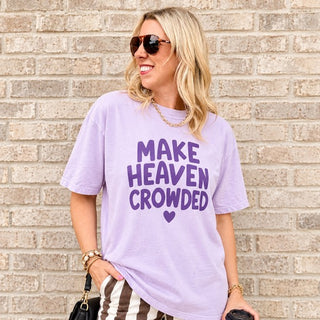Woman wearing the Make Heaven Crowded Comfort Colors Christian tee in Orchid with striped wide-leg pants
