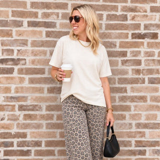 Woman wearing the Favorite Soft Solid Bella+Canvas Tee in Natural with leopard wide-leg jeans