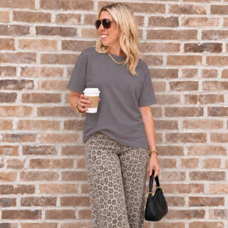 Woman wearing the Favorite Soft Solid Bella+Canvas Tee in Storm with leopard wide-leg jeans